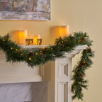 Blitzen Pine Lighted Garland – mixed fir and pine needles with pine cone clusters, snow powder, and 50 warm white flashing timer LEDs – Christmas Mercantile